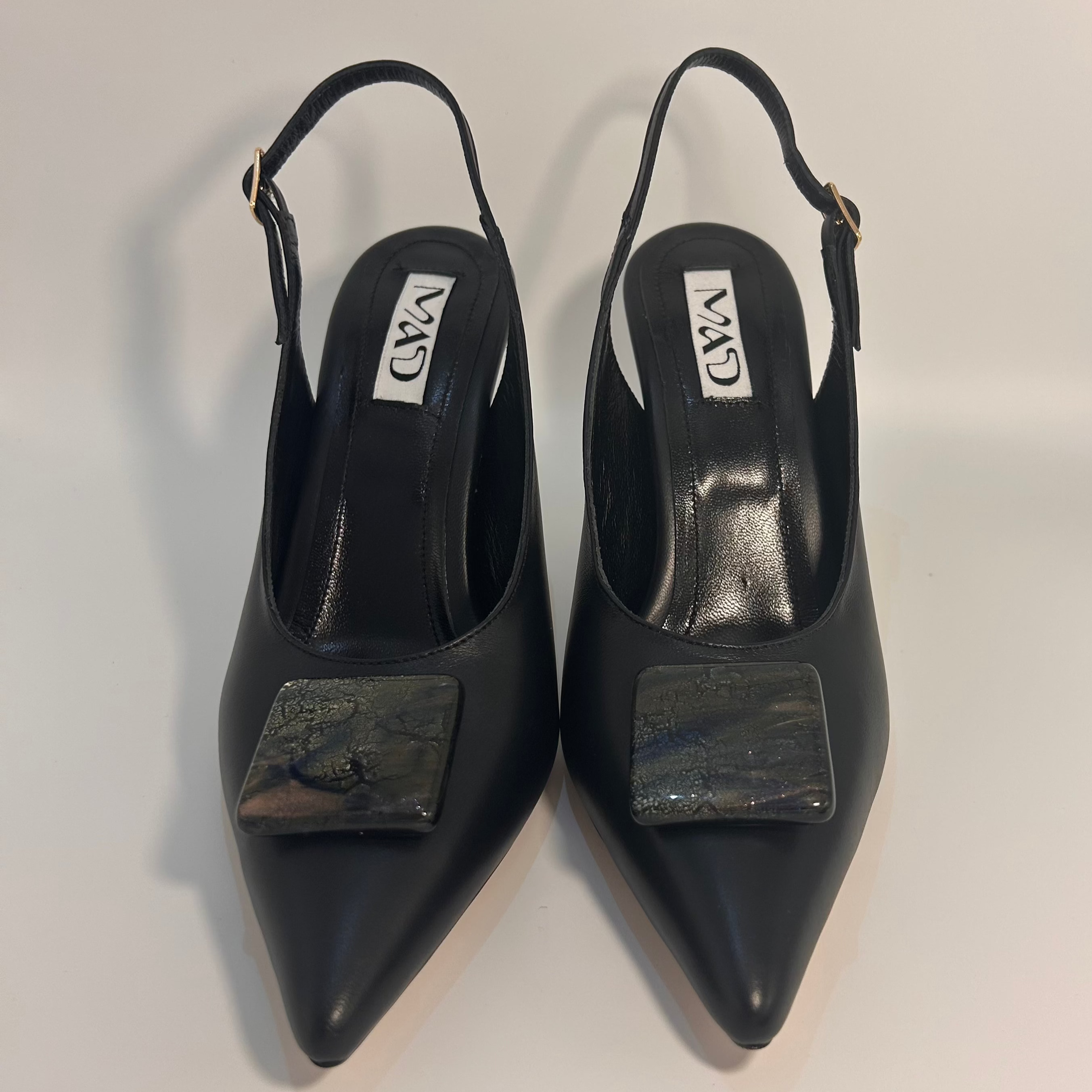 Black leather stiletto slingbacks with glass accessory pair