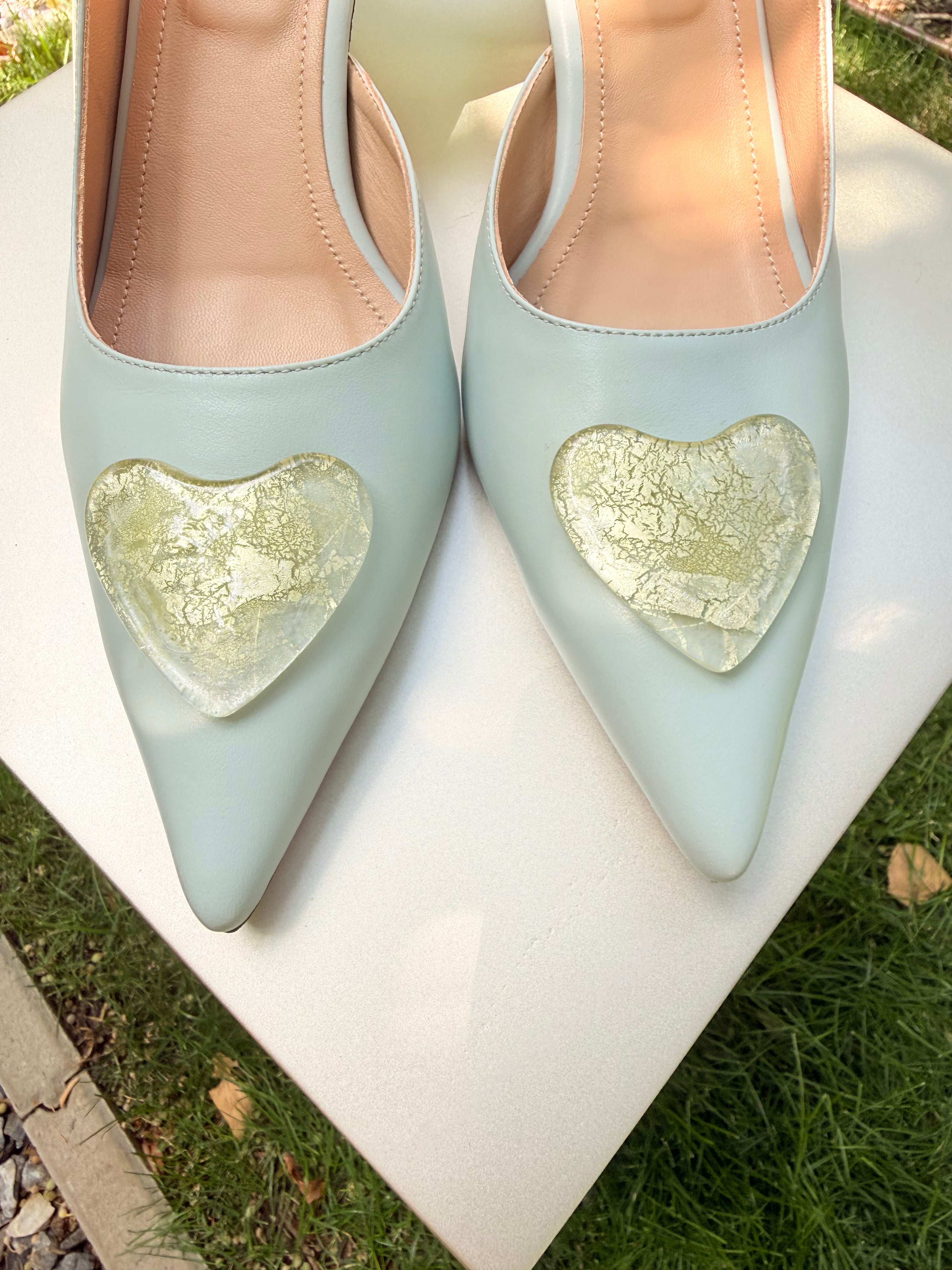 Baby blue pointed-toe heels with gold glass heart accessory
