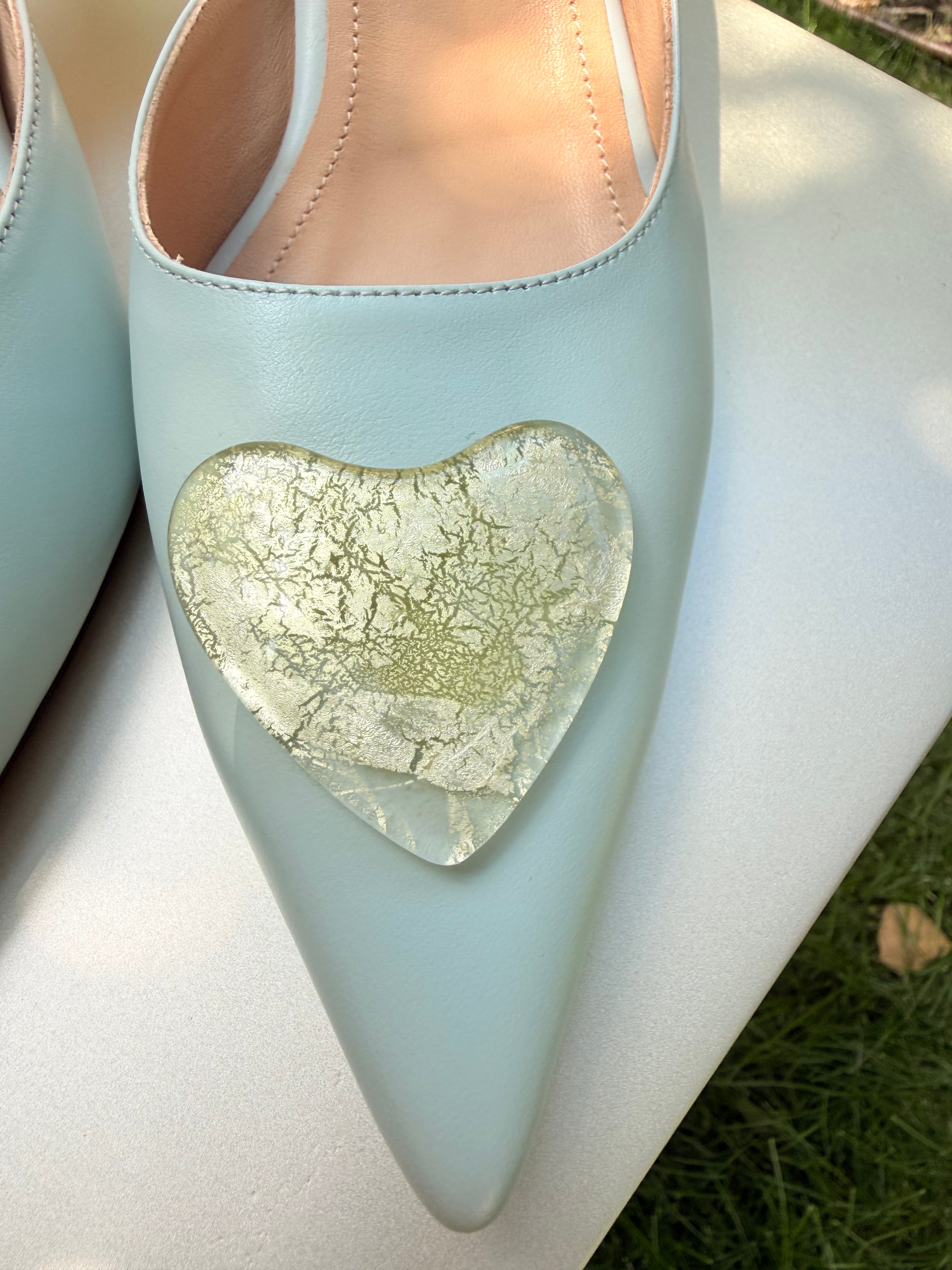Baby blue pointed-toe heel with gold heart accessory on the vamp